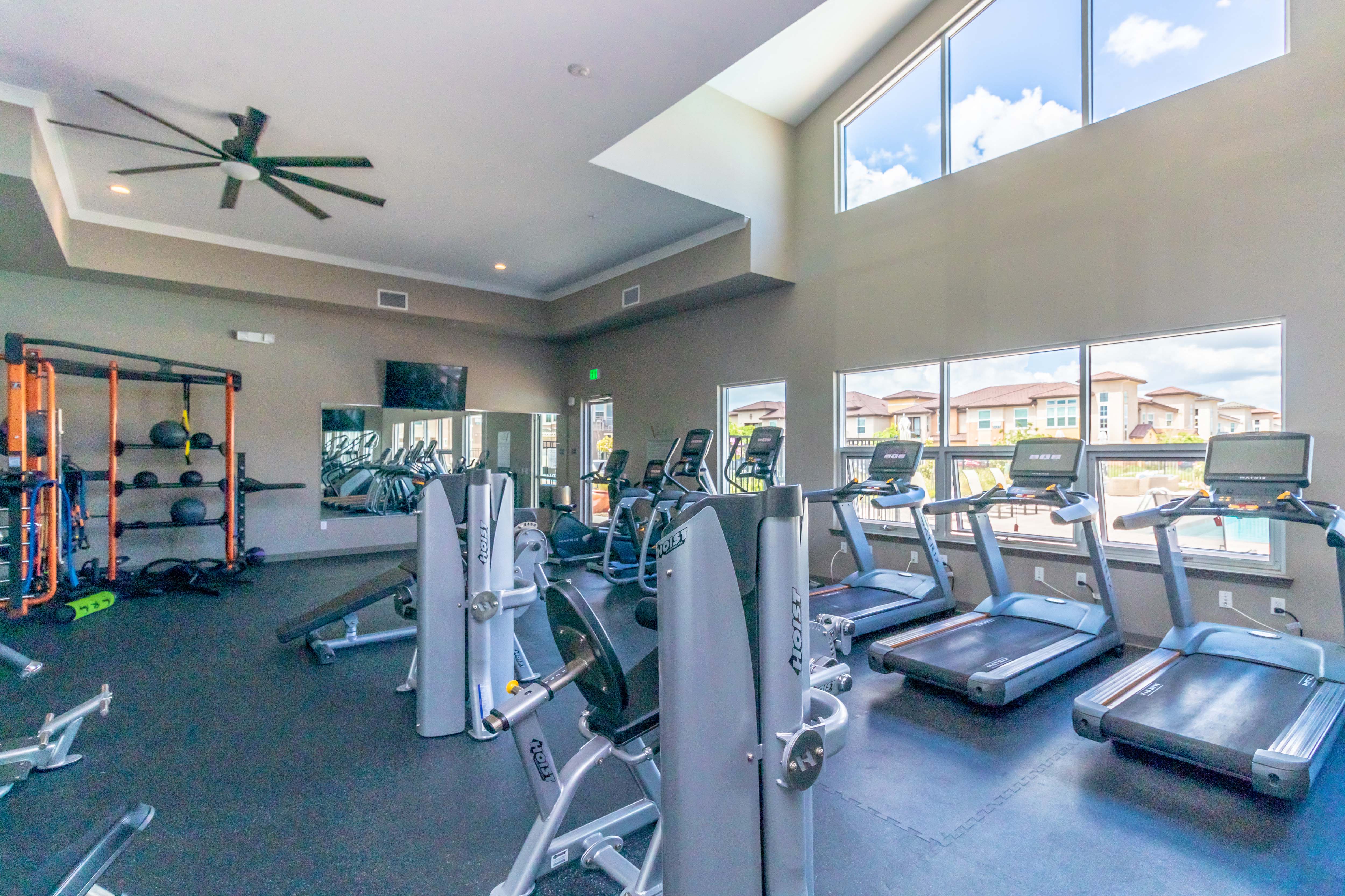 Apartments in Elk Grove CA - Expansive Fitness Center Featuring Various Cardio and Weight Equipment