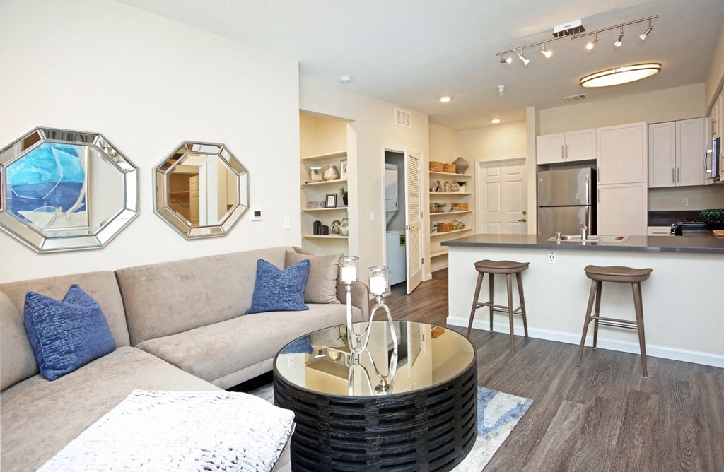 Elk Grove CA Apartments - Vasari Luxury Apartment Homes Living Room with Hardwood Flooring, Coffee Table, & Couch