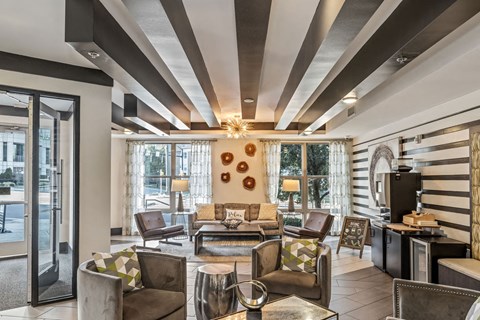 a living room with couches and chairs and a television