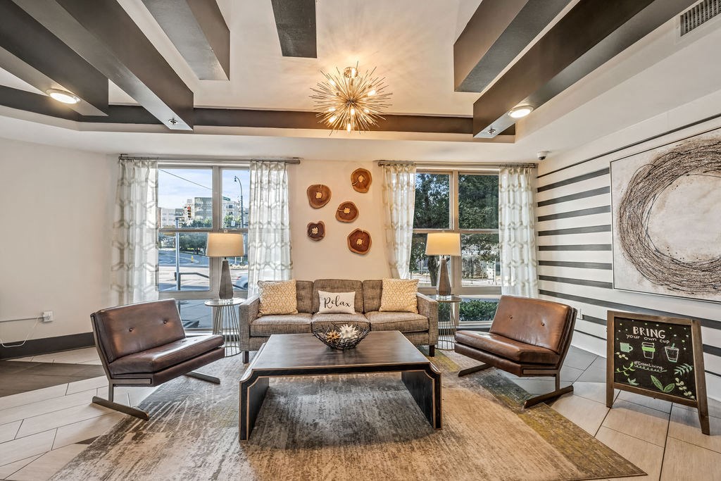 a living room with a couch and chairs and a table