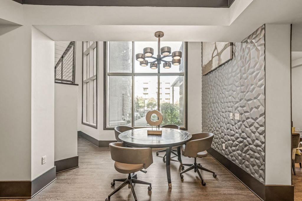 a dining room with a table and chairs and a large window