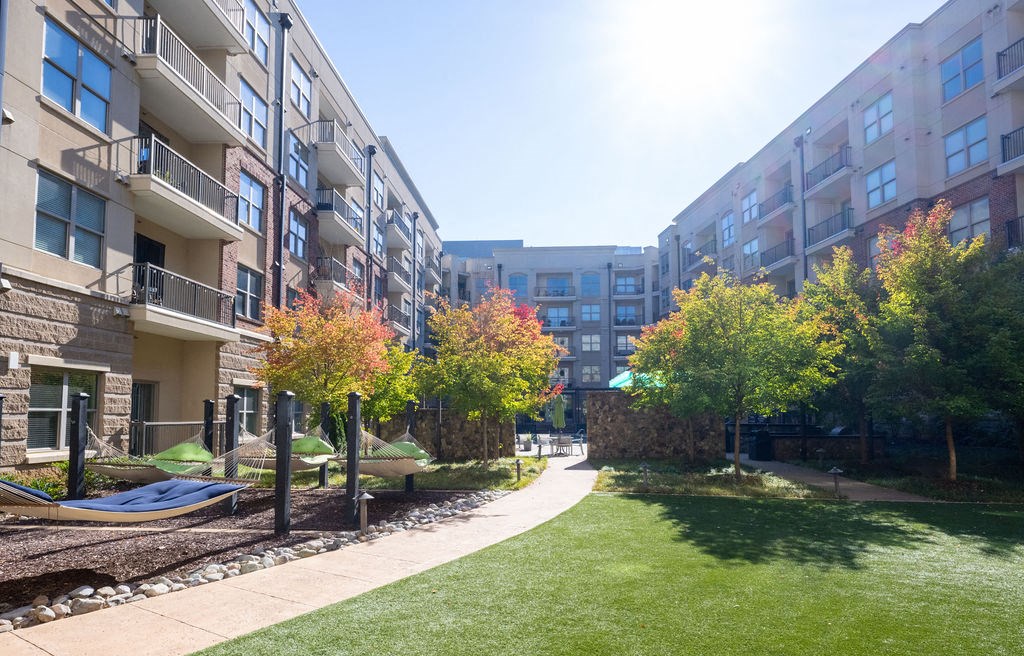 modern apartment buildings with a lawn and hammocks