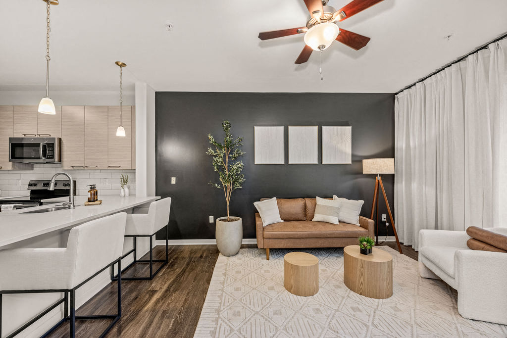 a living room with a couch and a kitchen