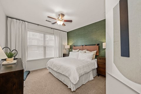 a bedroom with a bed and a ceiling fan