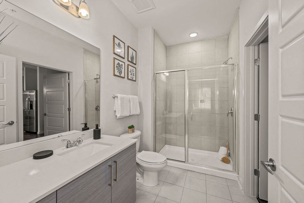 a white bathroom with a shower and a sink