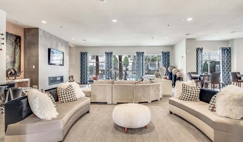 A modern living room with a large sofa and a television.