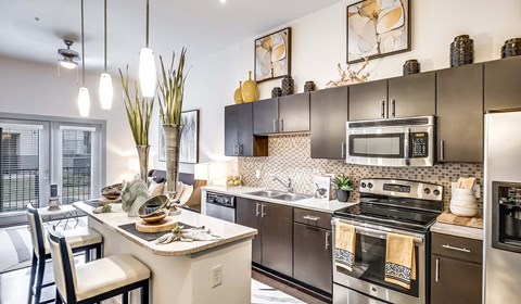 A modern kitchen with a stove top oven and microwave.