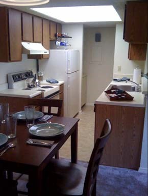A kitchen with a table set for two.