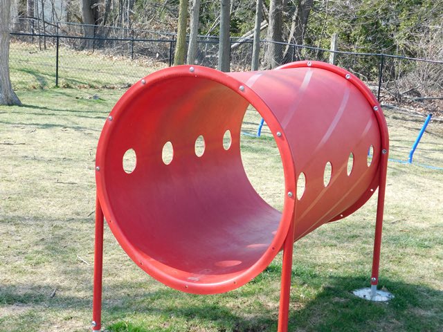 a red playground slide in a park