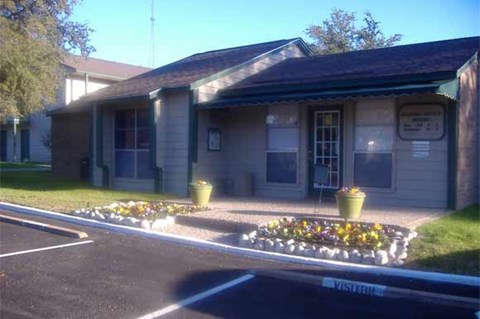 A building with a flower bed in front of it.