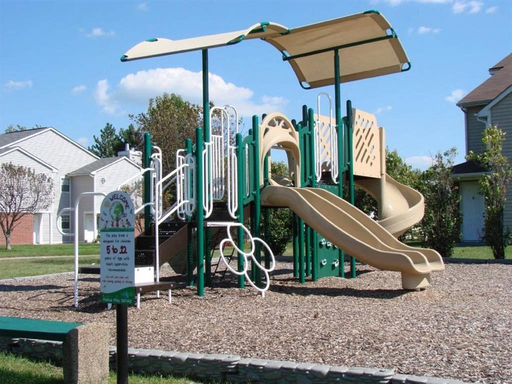 a playground with a swing set and slides