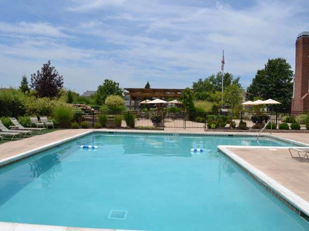 a swimming pool with umbrellas and chairs around it