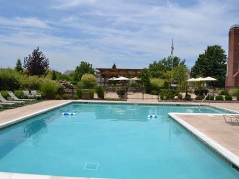 a swimming pool with umbrellas and chairs around it