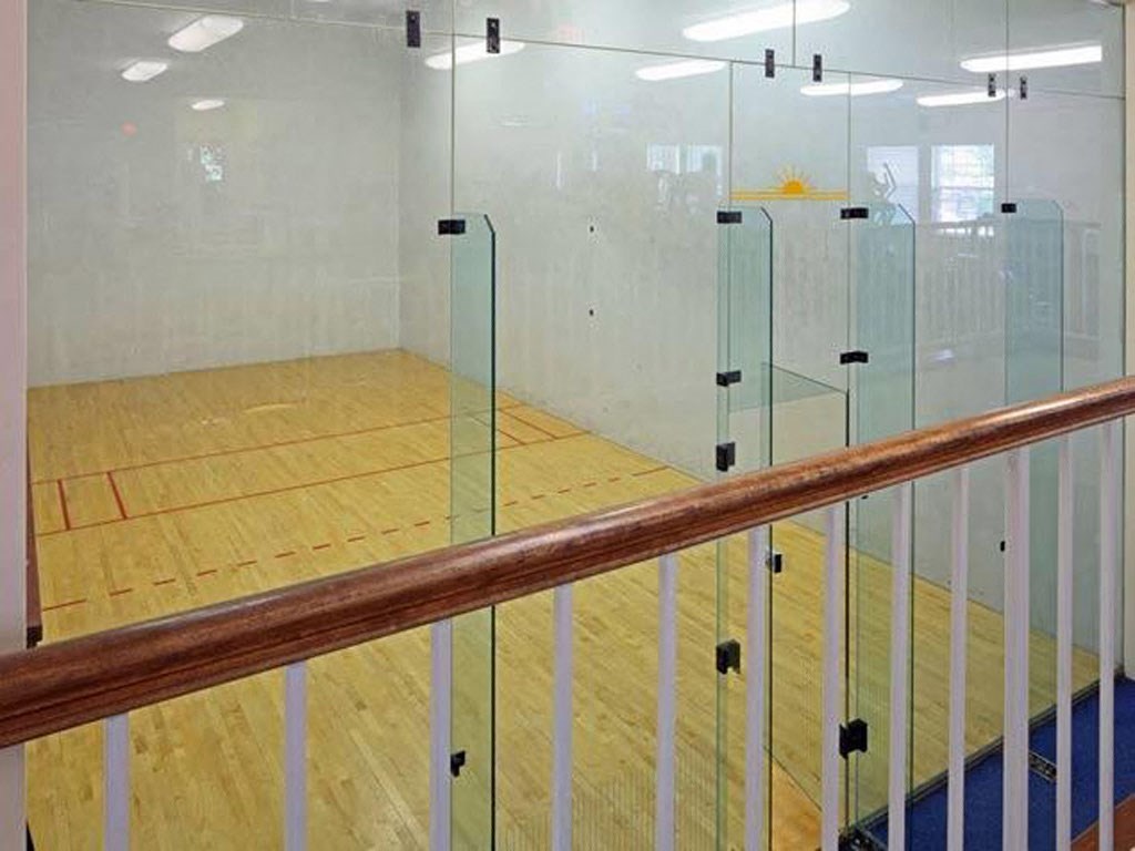 a squash court in a building with glass doors