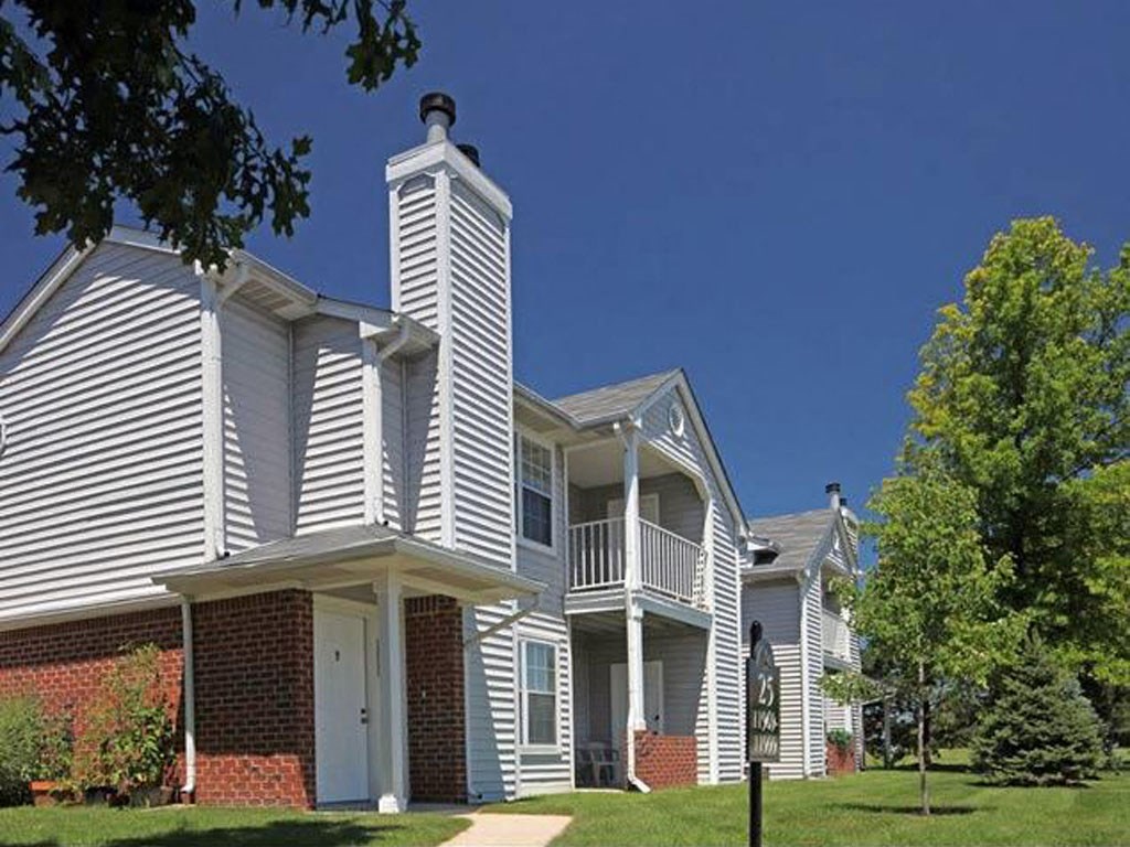 a group of white houses with trees in front of them
