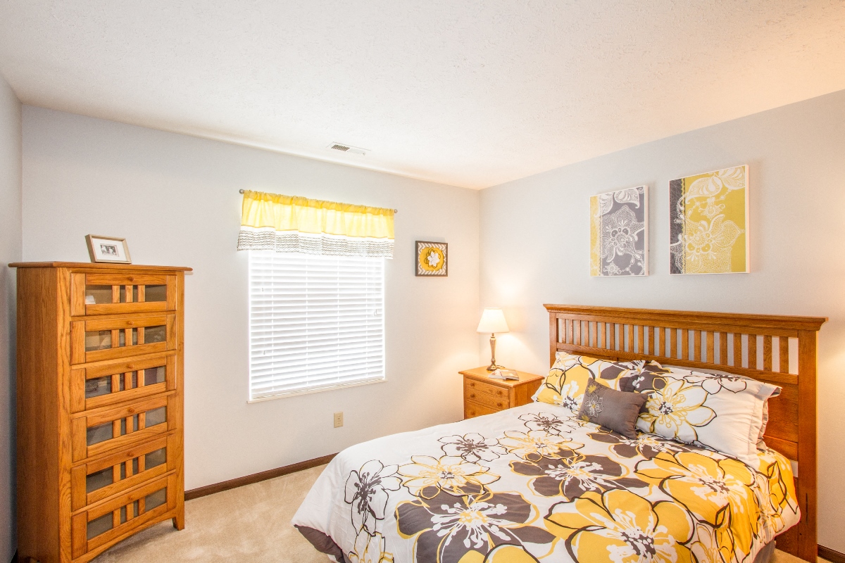 a bedroom with a bed and a dresser