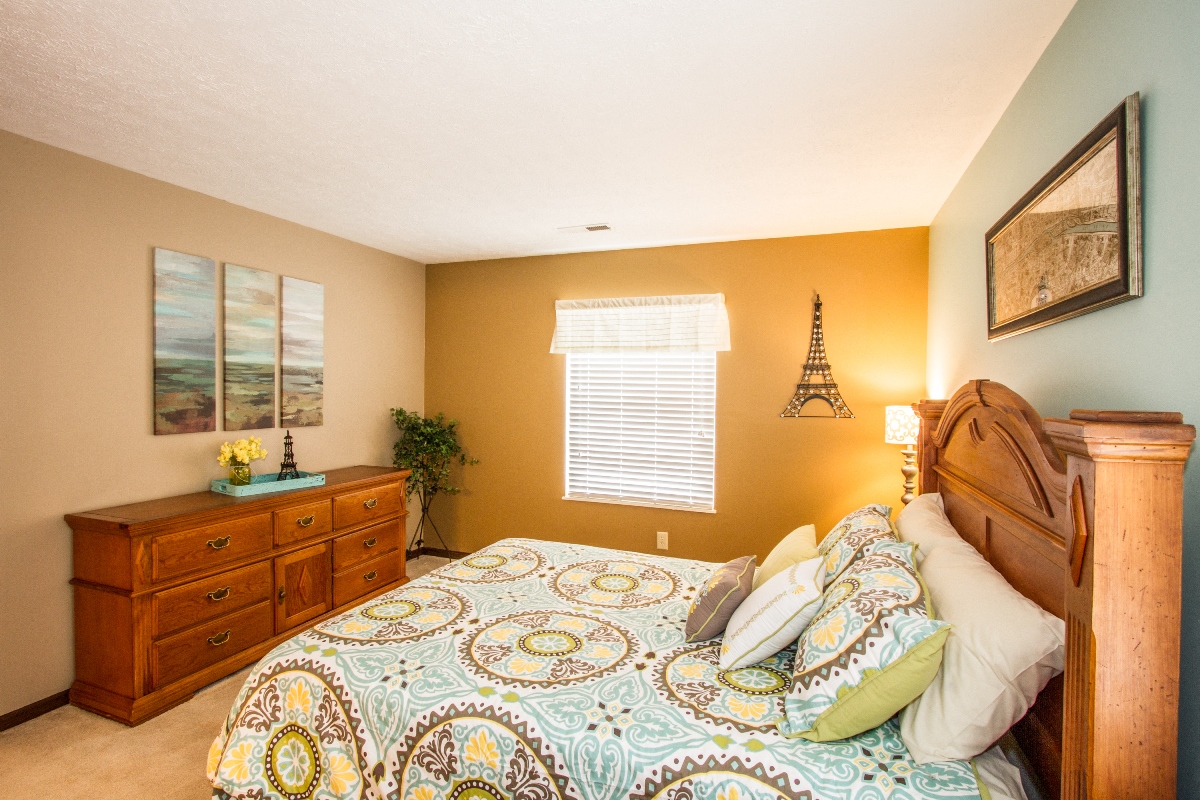 a bedroom with a bed and a dresser