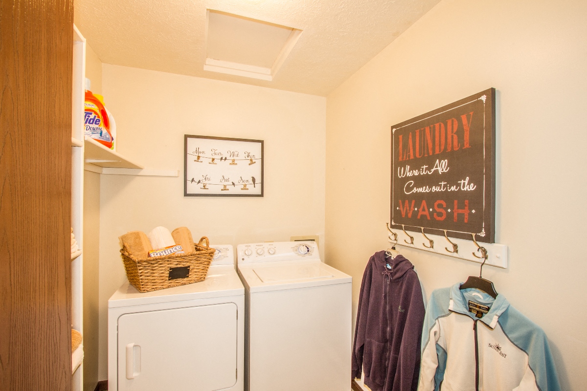 a washer and dryer in a laundry room with a chalkboard