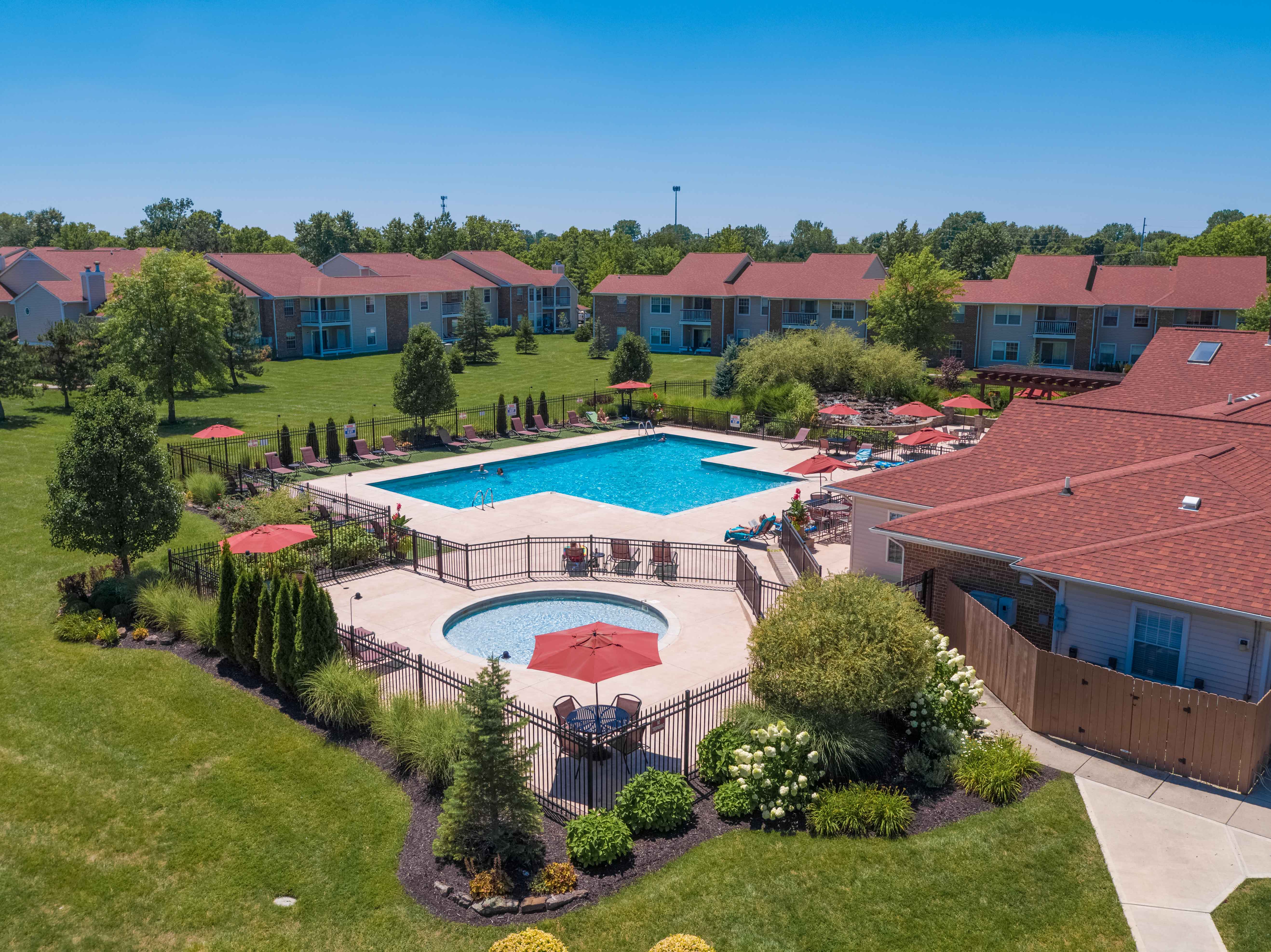 an aerial view of a swimming pool in a backyard with houses