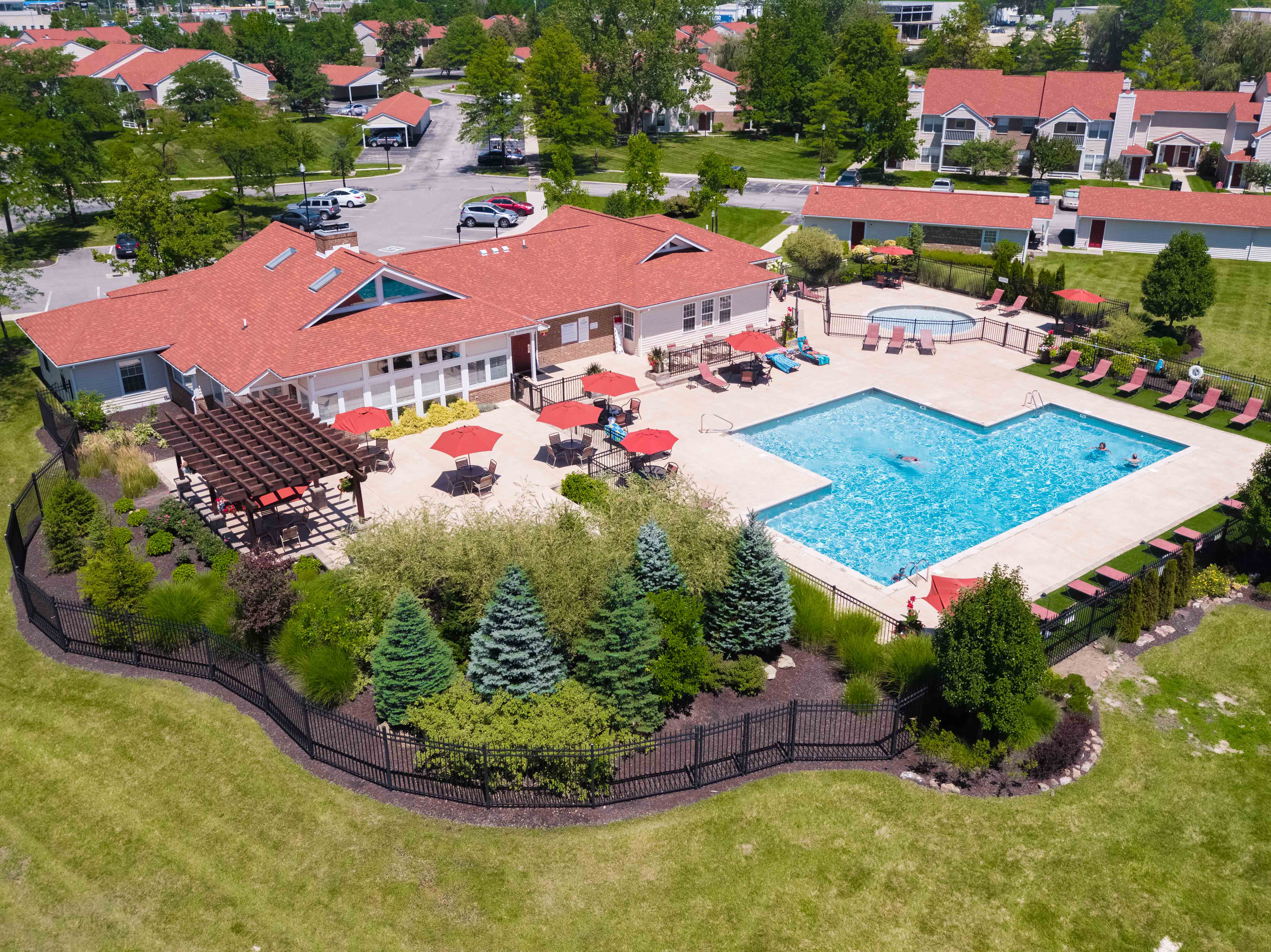 a birds eye view of a swimming pool in front of a mansion