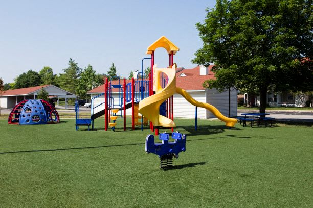 a playground with a yellow slide    and a blue