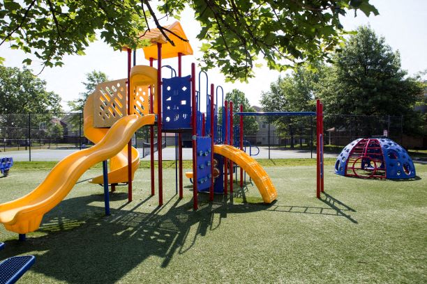 a playground with a slide and other toys in a park