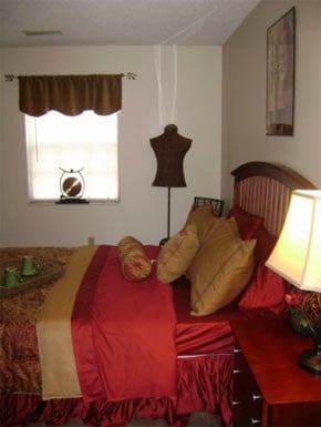 a bedroom with a bed and a lamp