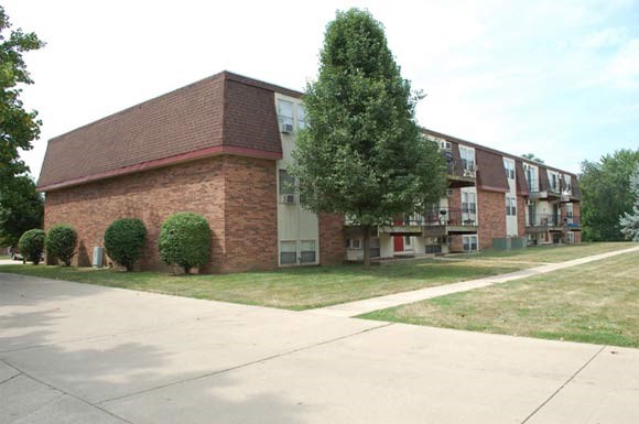 a large brick building with a tree in front of it