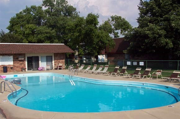 a large swimming pool with chairs around it