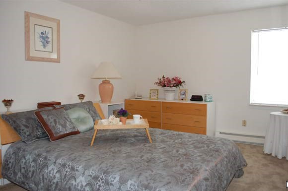 a bedroom with a bed and a table