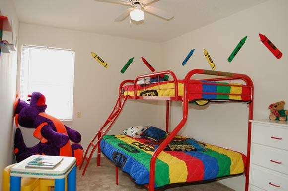 a bedroom with a bunk bed and a ceiling fan