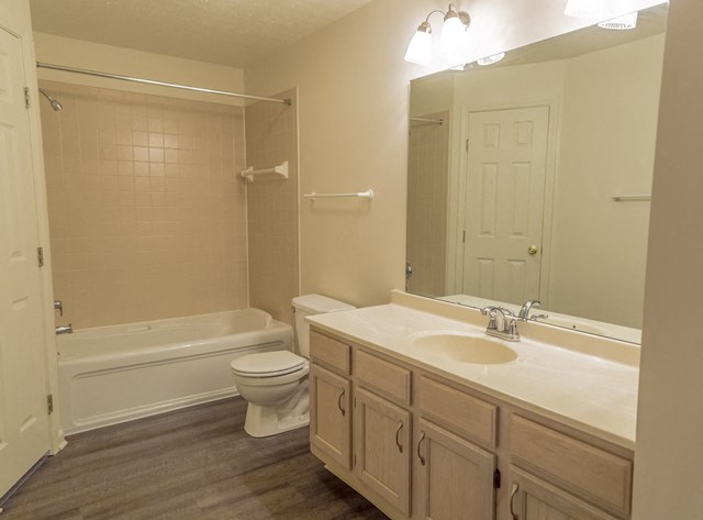 a bathroom with a sink toilet and a bath tub