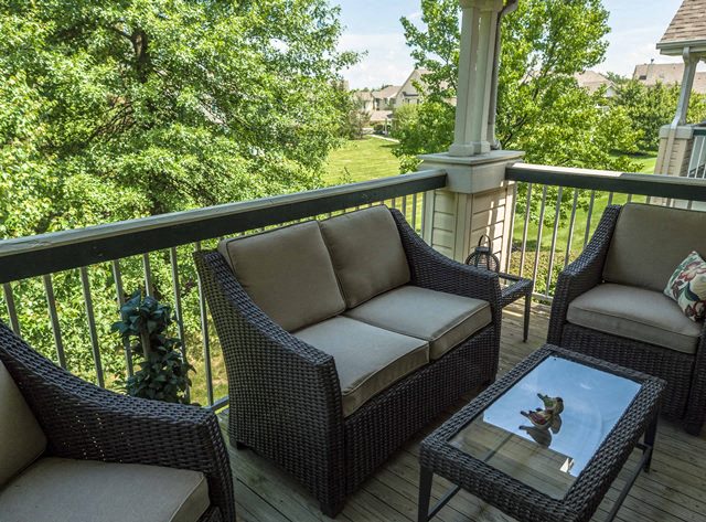 a patio with chairs and a table on a balcony