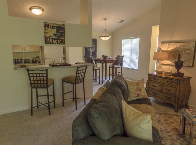 a living room with a couch and a table and chairs