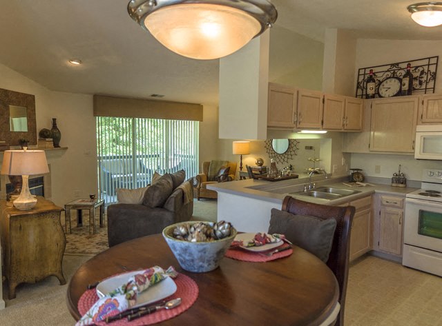 a kitchen and living room with a dining table