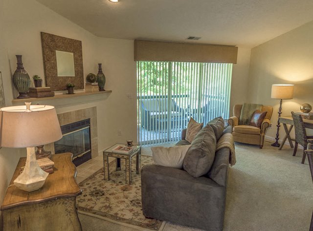 a living room with a couch and a fireplace