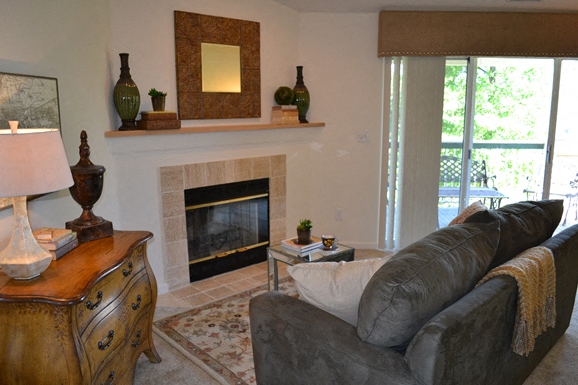 a living room with a couch and a fireplace