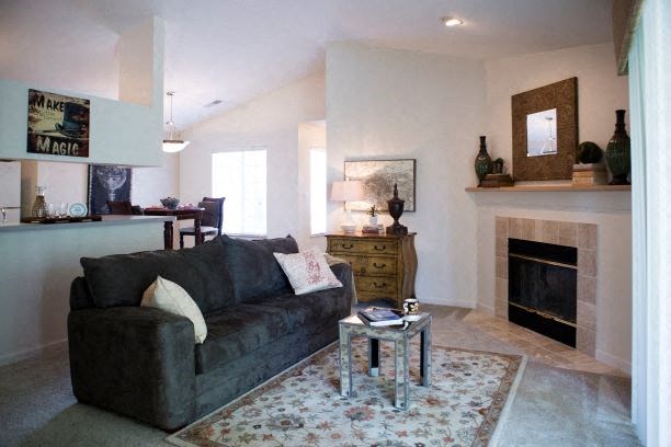 a living room with a couch and a fireplace