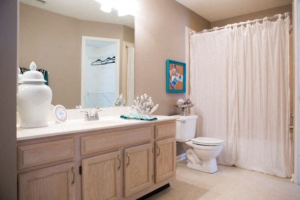 a bathroom with a toilet and a sink and a shower