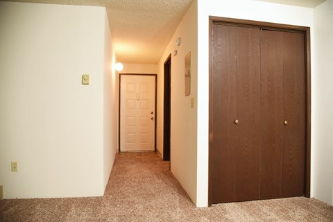 a bedroom with a closet and a door to a bathroom