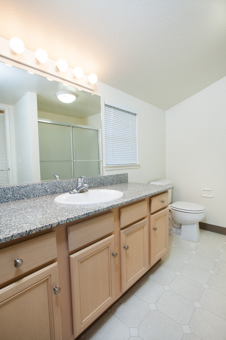 a bathroom with a sink toilet and mirror