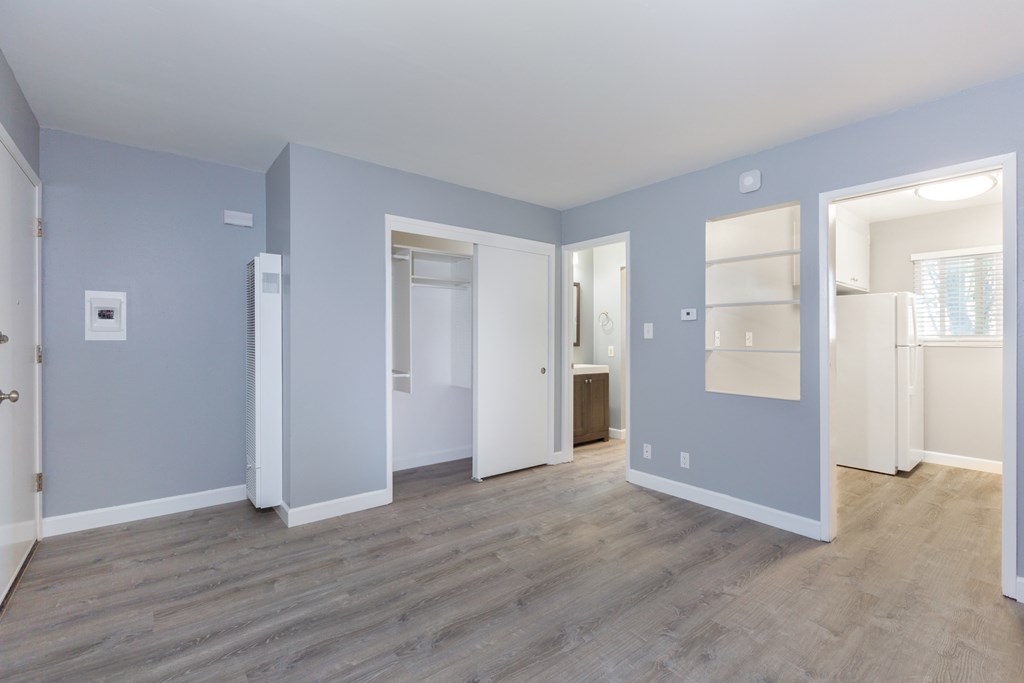 a living room with blue walls and a door to a bathroom