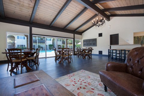 the living room and dining area of a house with a pool