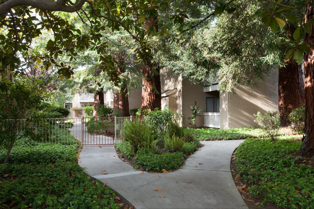 a walkway in front of an apartment building