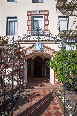 an entrance to a building with a wrought iron gate