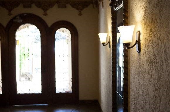 a room with windows and a light on the wall