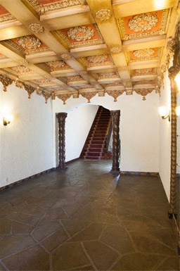 a staircase in a room with a white wall and a ceiling