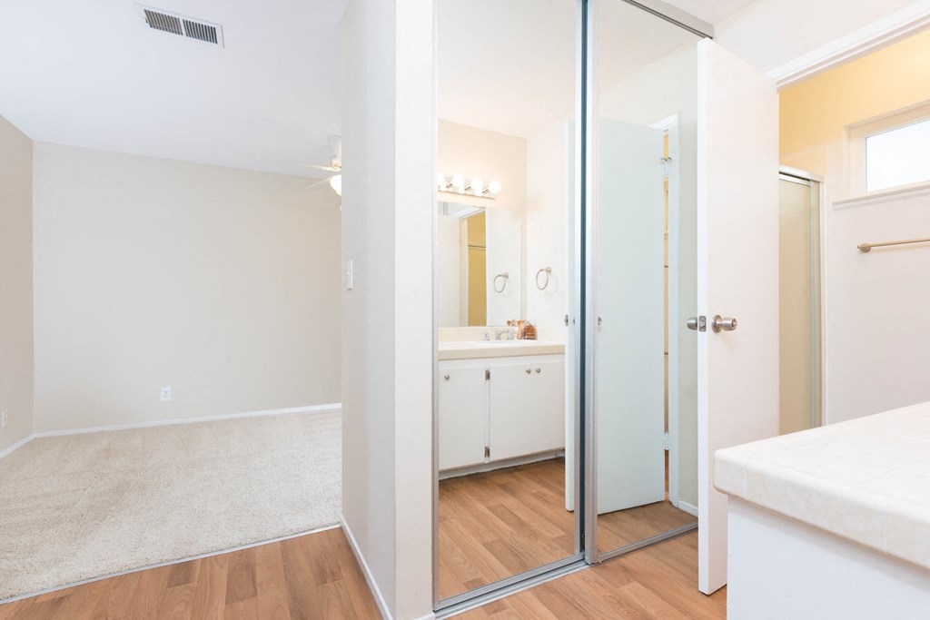 a bedroom with a bed and a mirror