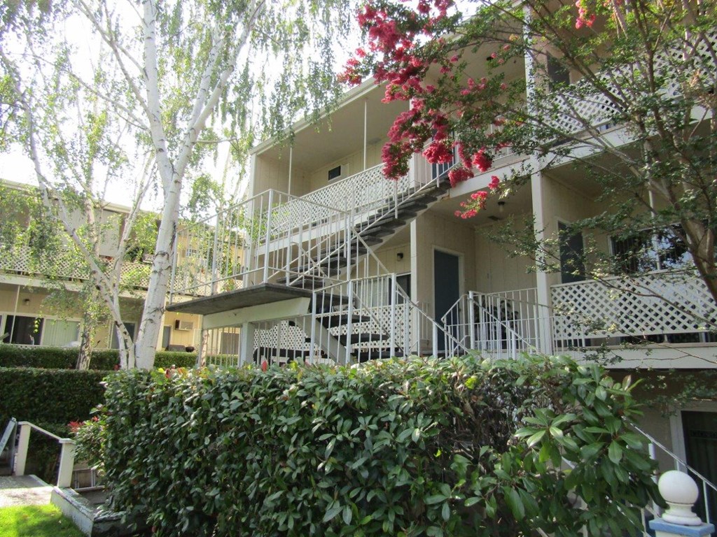 the exterior of an apartment building with stairs