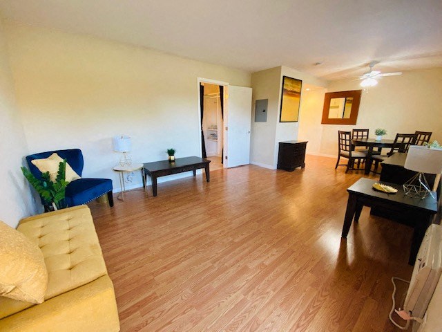 a living room and dining room with a wood floor